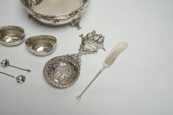 An early 20th century Austro-Hungarian white metal bowl, diameter 13.5cm, a pair of small silver oval salts with spoons, a silver butter knife and an ornate 800 standard white metal spoon.